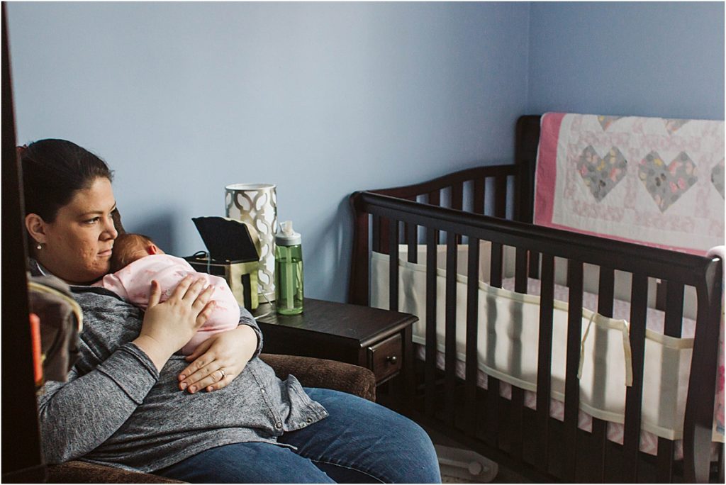 Stephanie Anderson rocks her newborn daughter in her nursery.
