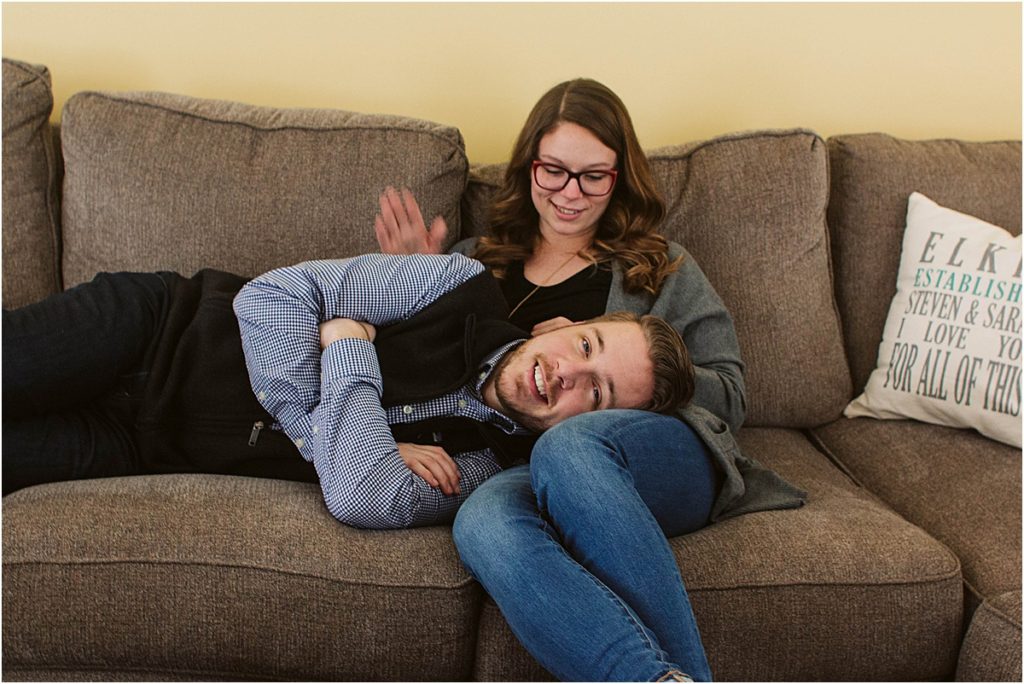 Flint couple Steven & Sarah snuggle up on the couch of their downtown home.