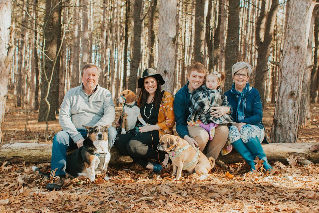 Grand Rapids couple Chase and Traci pose with their daughter, dogs and Traci's parents at Provin Trails.