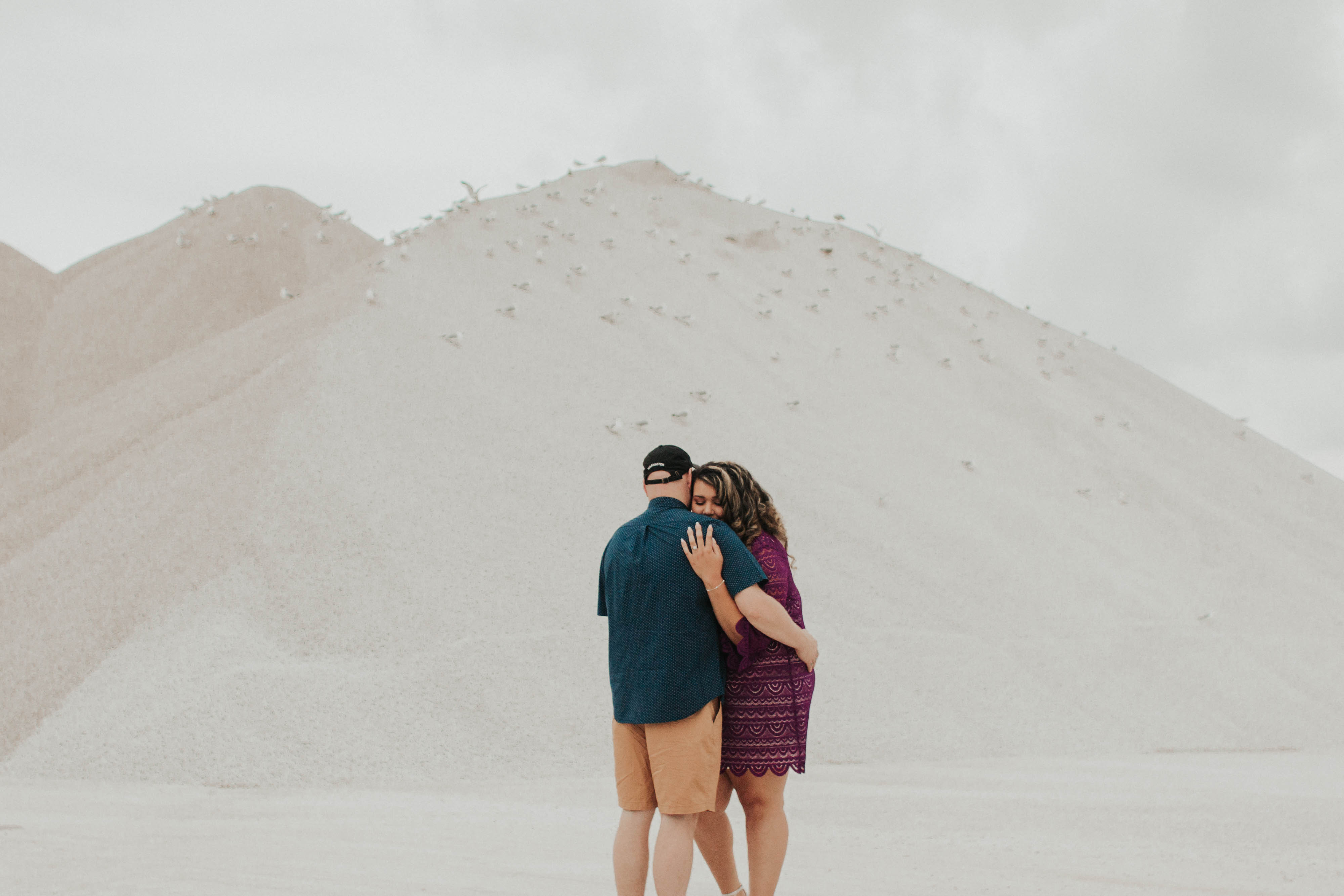 holland michigan couple hugging in gravel pit during engagement photos
