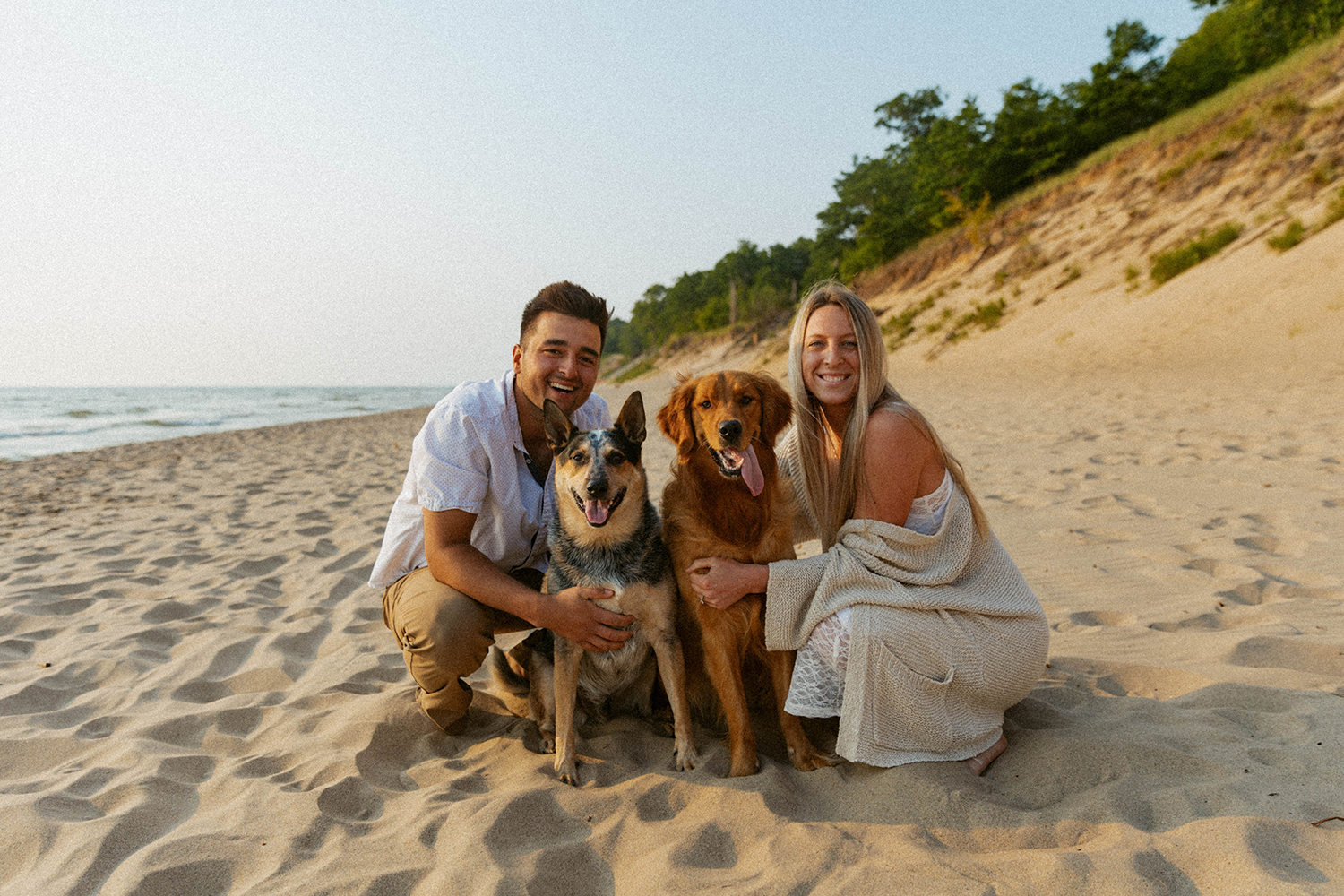Couple poses with their two dogs at Kirk Park Beach.