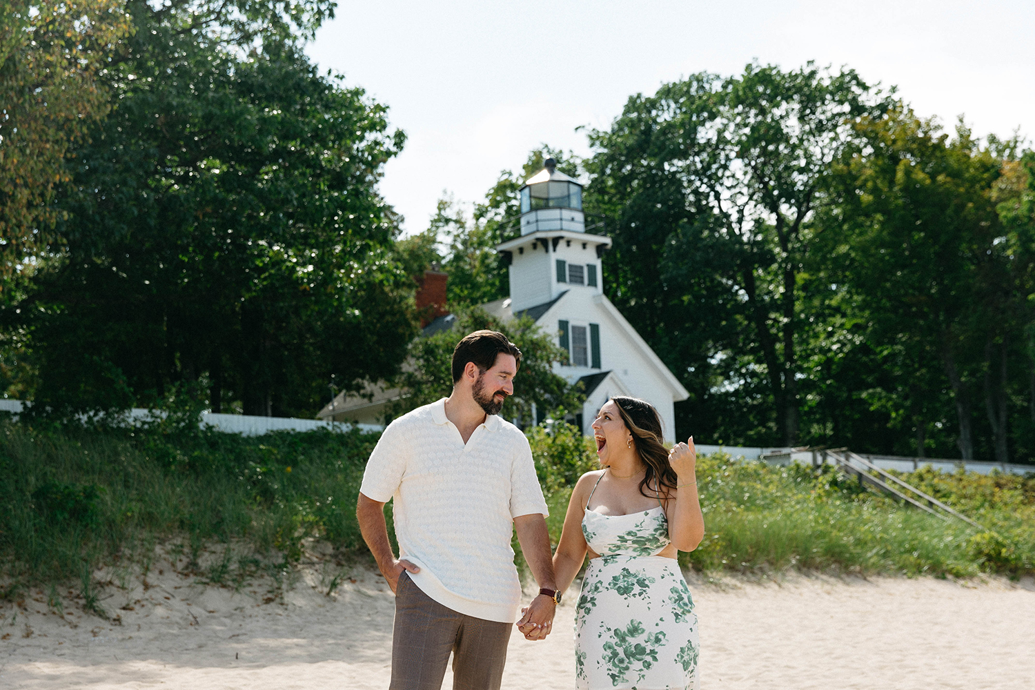 Couple posing together at their proposal at Mission Point Lighthouse