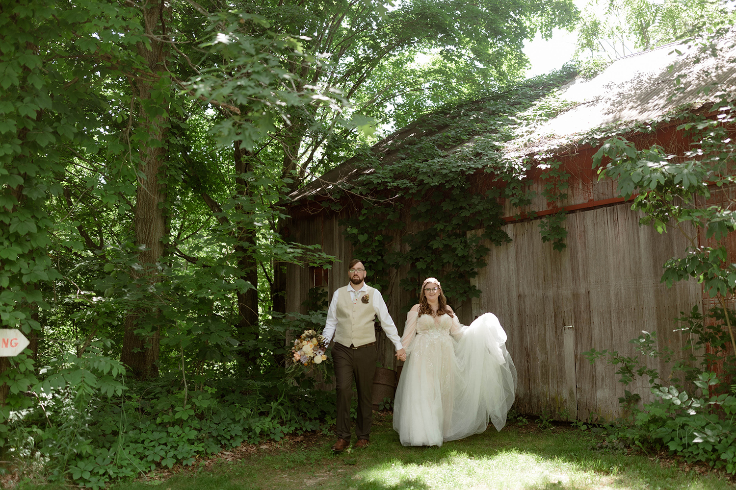 Bride and Groom walk hand in hand at their wedding at Millcreek Wilde.