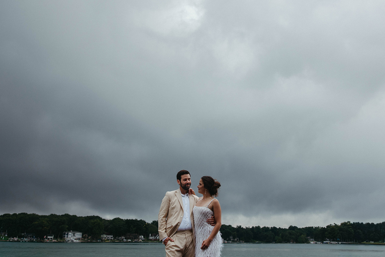 Bride and groom posing together on the dock of their Gull Lake Island Elopement celebration.